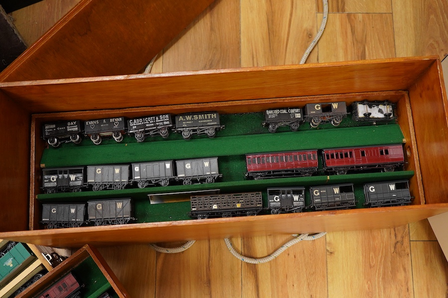 130 items of EM gauge model railway rolling stock contained within three handmade fitted wooden cases, two with removable trays, comprising three locomotives; an SR class 700 0-6-0 tender locomotive, 693, an SR 0-4-0T, 7